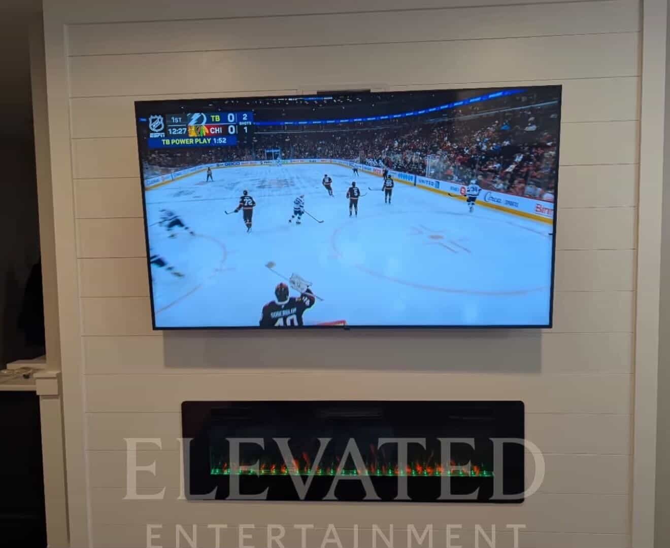 TV flush mounted on a white shiplap wall by Elevated Entertainment